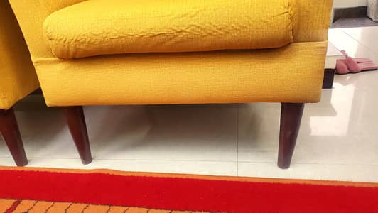 two mustard chairs with cushion slightly used