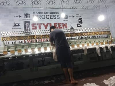 Embroidery machine operator or assistant