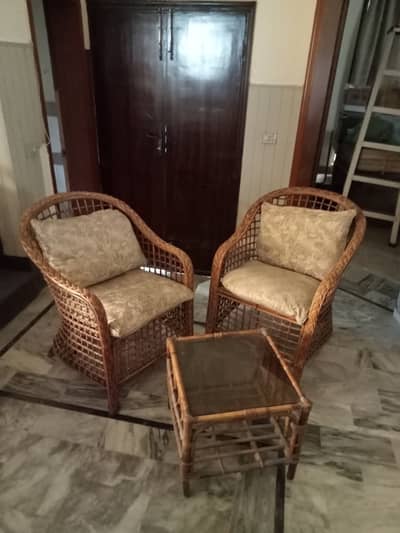 2 single cane chairs with small center table
