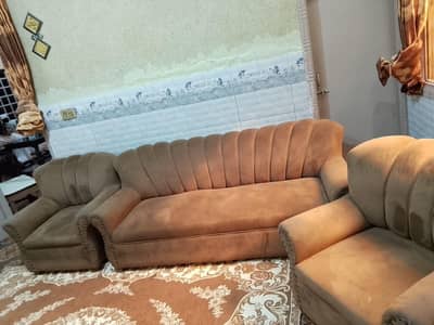 5 seater sofa in brown colour with velvet stuff.
