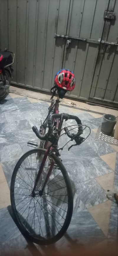Racing cycle with helmet