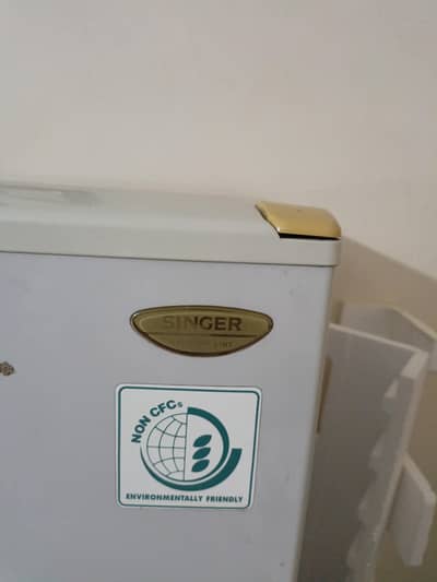 Singer Company, small fridge. 50 inch height. along with wooden stole.