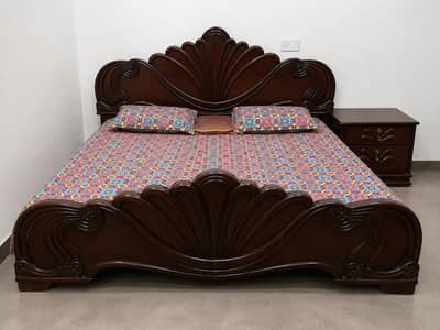 double bed with dressing table side table and metress