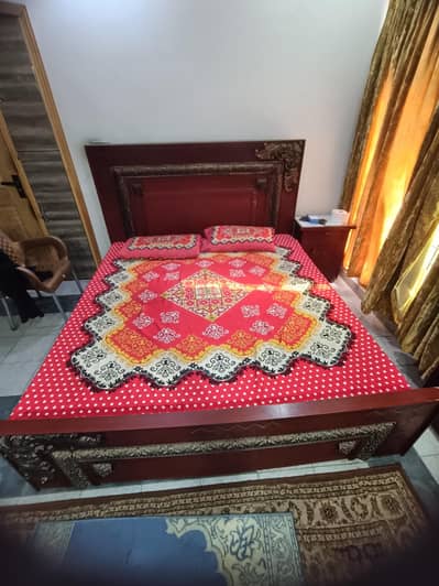 Wooden king size bed with side tables