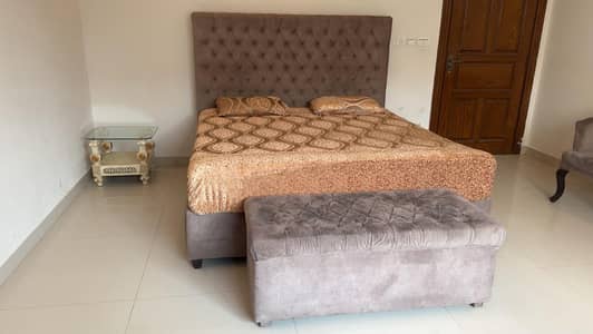 Double bed velvet fabric with puffy and mirron along 2 chairs and tabl