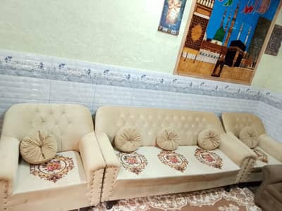 5 seater sofa in skin and  brown colour with velvet stuff.