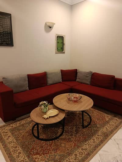 Maroon sofa with grey and maroon cushions