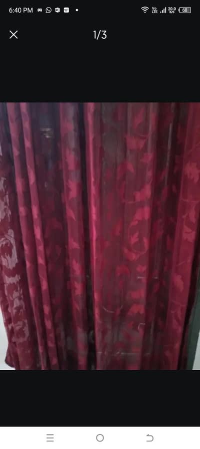 two mhroon net curtains