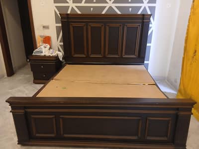 wooden bed with two side tables
