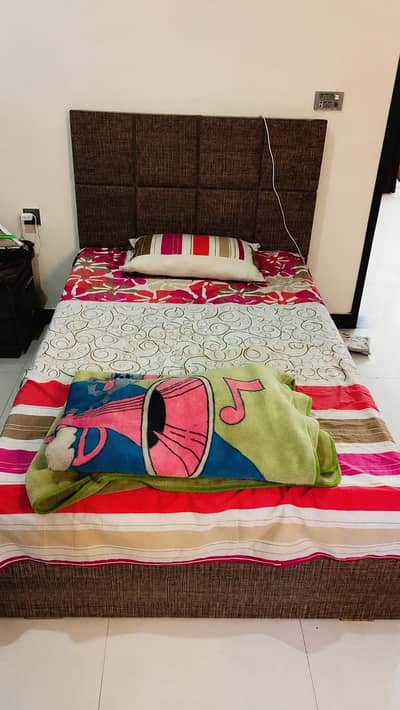 single wooden bed with mattress