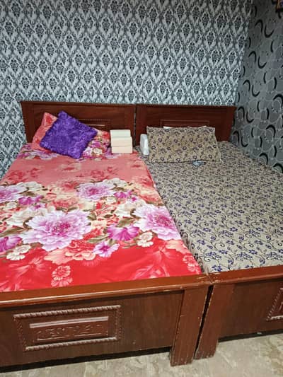 2 single bed with mattress and one side table