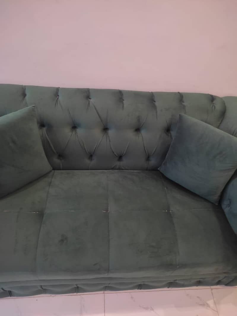 two green sofas and table 1