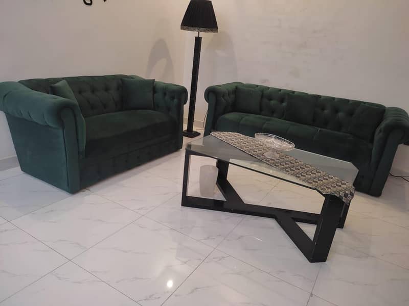 two green sofas and table 2