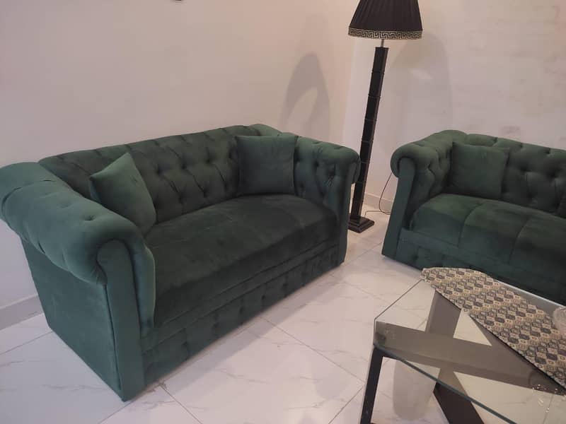 two green sofas and table 3