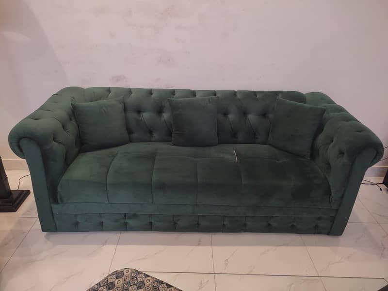 two green sofas and table 4