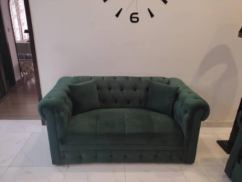 two green sofas and table 5