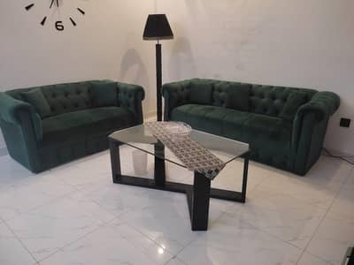 two olive green sofas and table