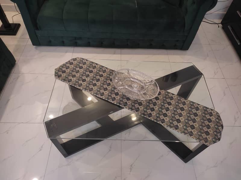 two green sofas and table 7