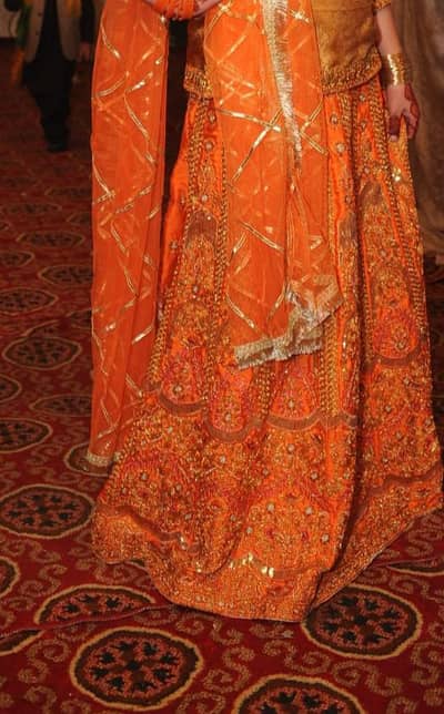 Heavily Embroidered Orange Lehnga with Net Dupatta