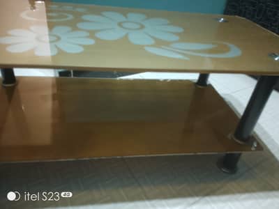 table made of glass is for sale with two racks