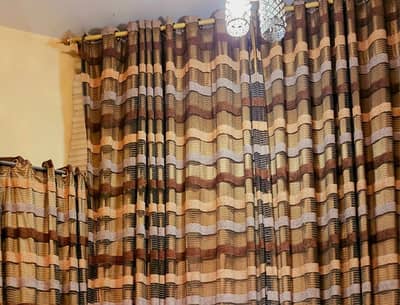 Pair of long curtains with lining.