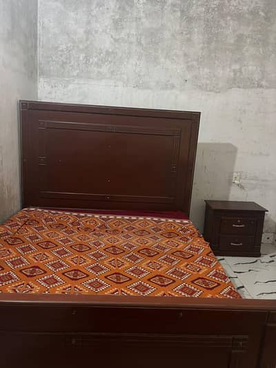 King size wooden bed with mattress and side table