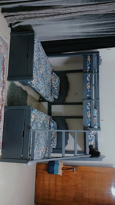bunk bed with stairs and two drawer along with one side table