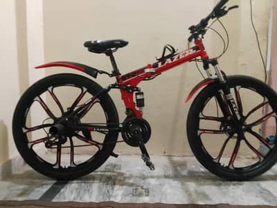 -lazer L-126 folding mountain bike - 8 speed 1 months used, alloys rim