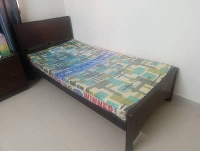 Single bed with side table and mattress