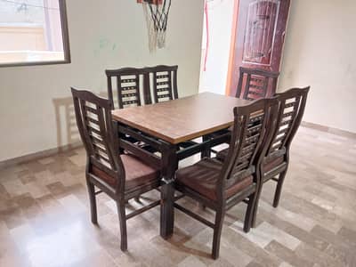 Dining table with 6 chairs available for sale.