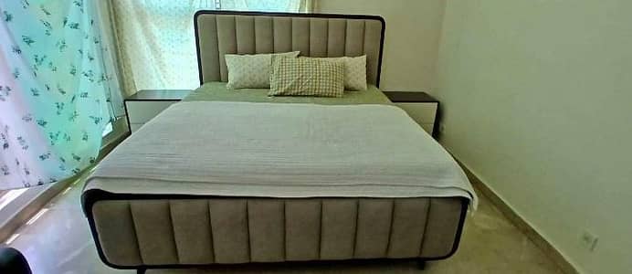 Double bad with dressing and side tables