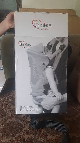 Tinnies 10/10 condition baby carrier in grey colour