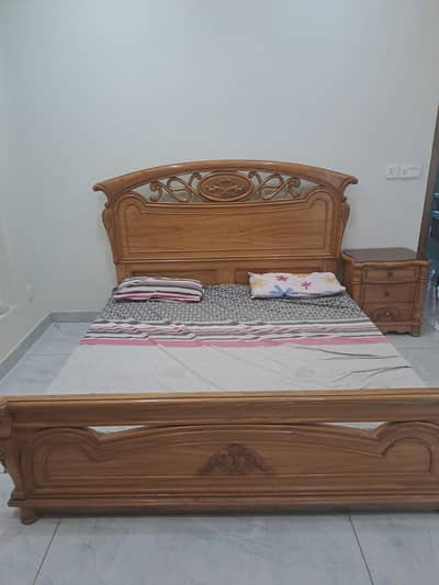 Wooden bed with side tables and dressing table