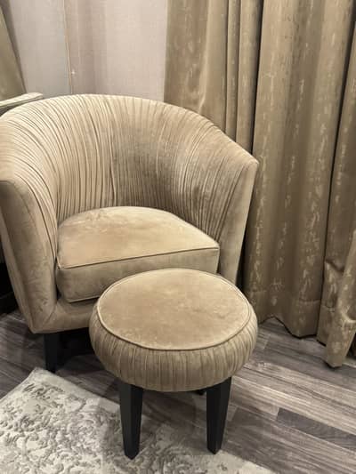 Bed set with side tables and lamps and corner chair with foot rest