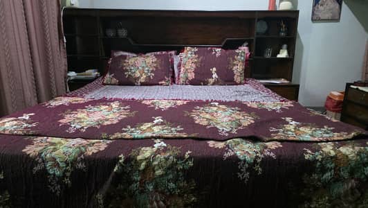 wooden double bed with attached side tables and bneath storage