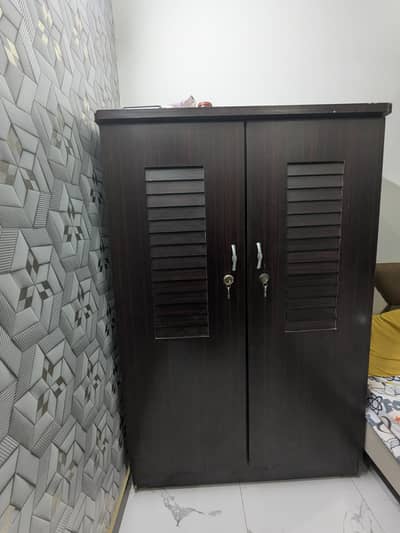 Wooden double size cupboard brown color