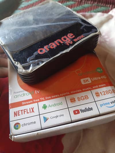 Orange Android tv box with box and charger