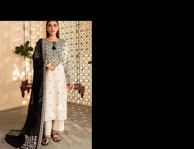 Elevate your wardrobe with this exquisite 3 Pcs Women's Stitched Suit