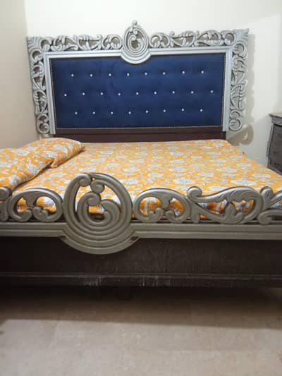 king size carved wooden bed with navy bluevylvet headboard