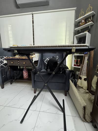 Full sized piano along with a stand
