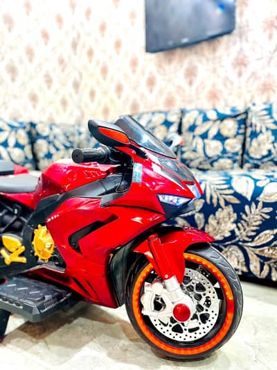 Brand new red kids electric ride on spot bike with training wheel