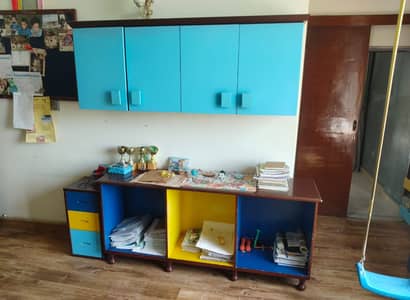 Blue deco finish cabinet and rack made by Habit children's store. .