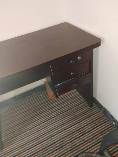 a wooden table with a chair study table