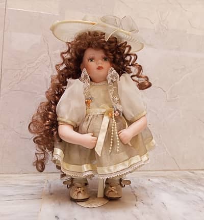 Vintage porcelain collector doll green eyes and long,curly brown hair