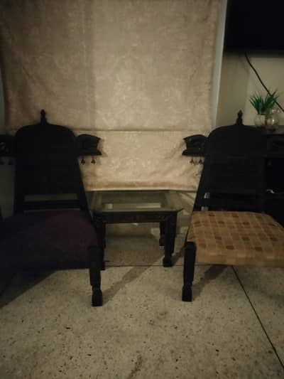 A round tyre table, tripod stand, two wooden chairs with glass top t,