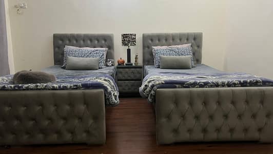 Grey single beds with center side table