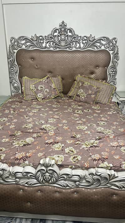 bed with two side tables and dressing table
