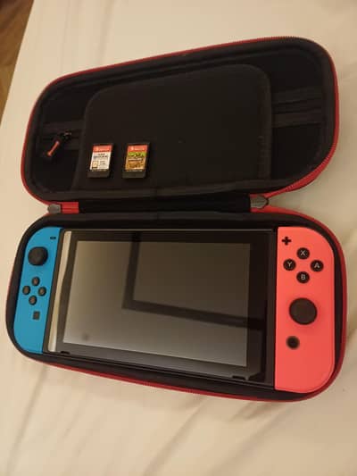 Nintendo switch with a case and two games  good condition