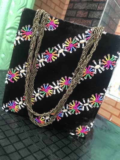 Hand embroidery bag for girls in black color with beautiful charms