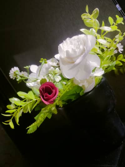 Beautiful artificial flowers with vase